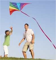 dad flying a kite with son