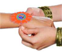 a sister ties a rakhi bracelet to her brother's wrist