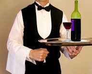 restaurant waiter delivering a wine order